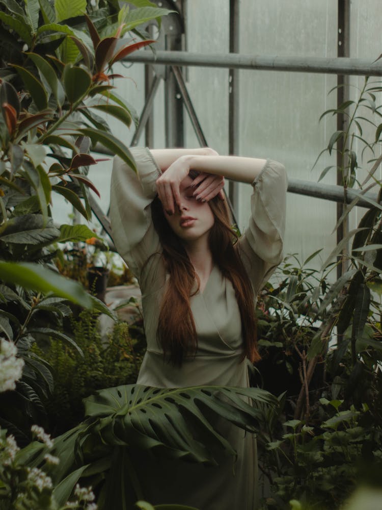 Woman In Green Drees Standing Near Green Plants