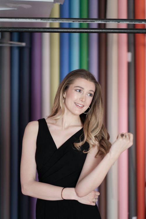 Free Stylish portrait of a young woman in a black dress, posing against a colorful backdrop. Stock Photo