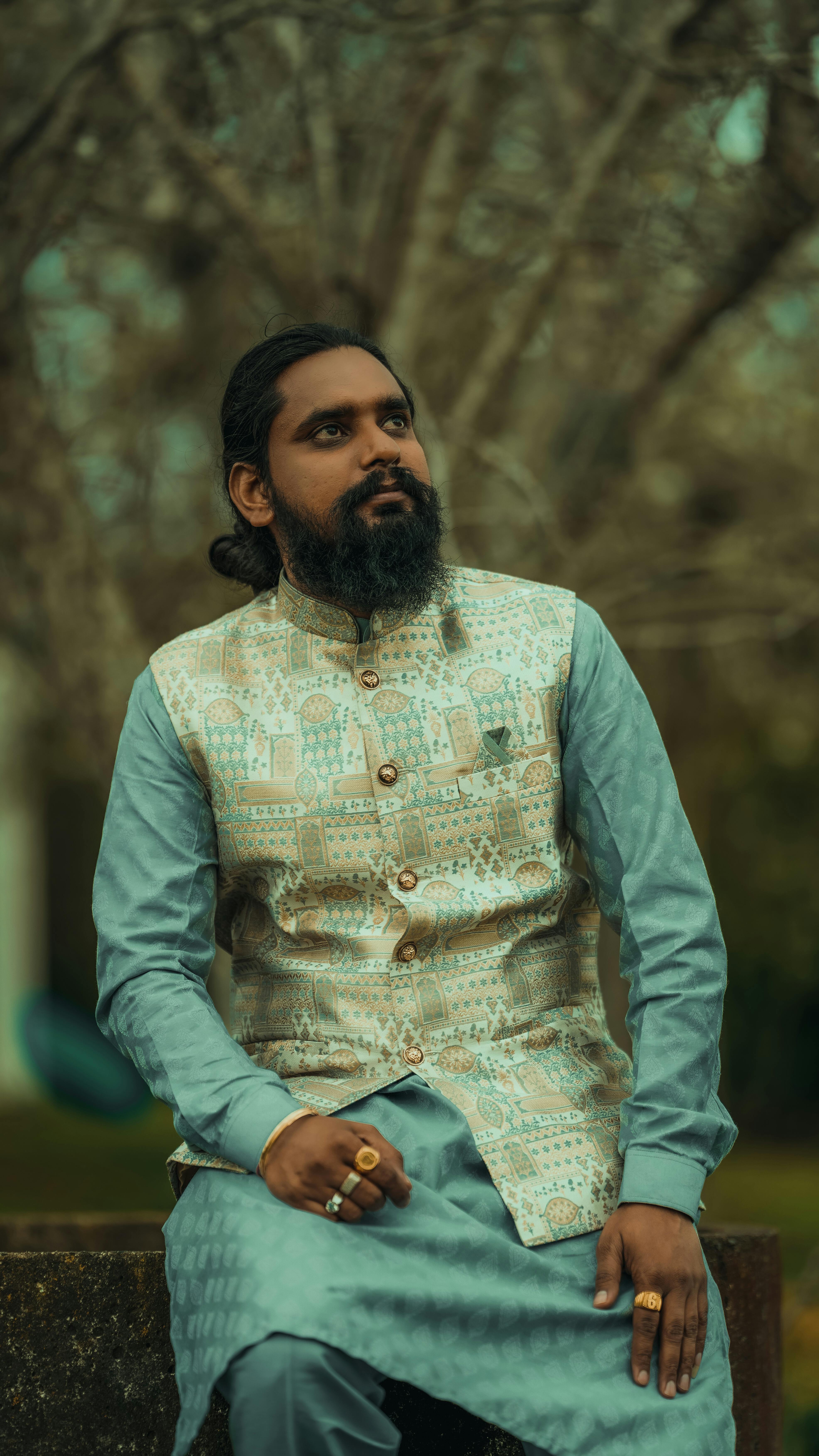 Man in grey sherwani seated
