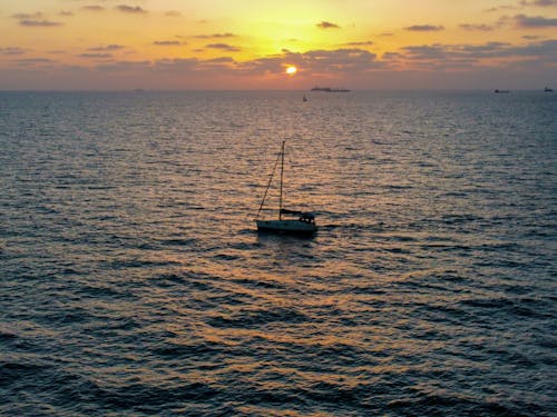 Sailboat in the Sea During Sunset