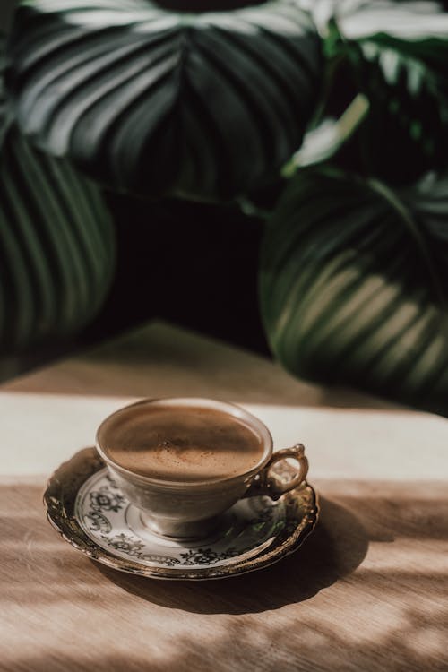 Free Coffee in Beautiful Cup on Table Stock Photo