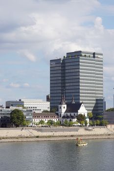 The Lanxess Tower and Cologne riverside captured on a clear summer day.