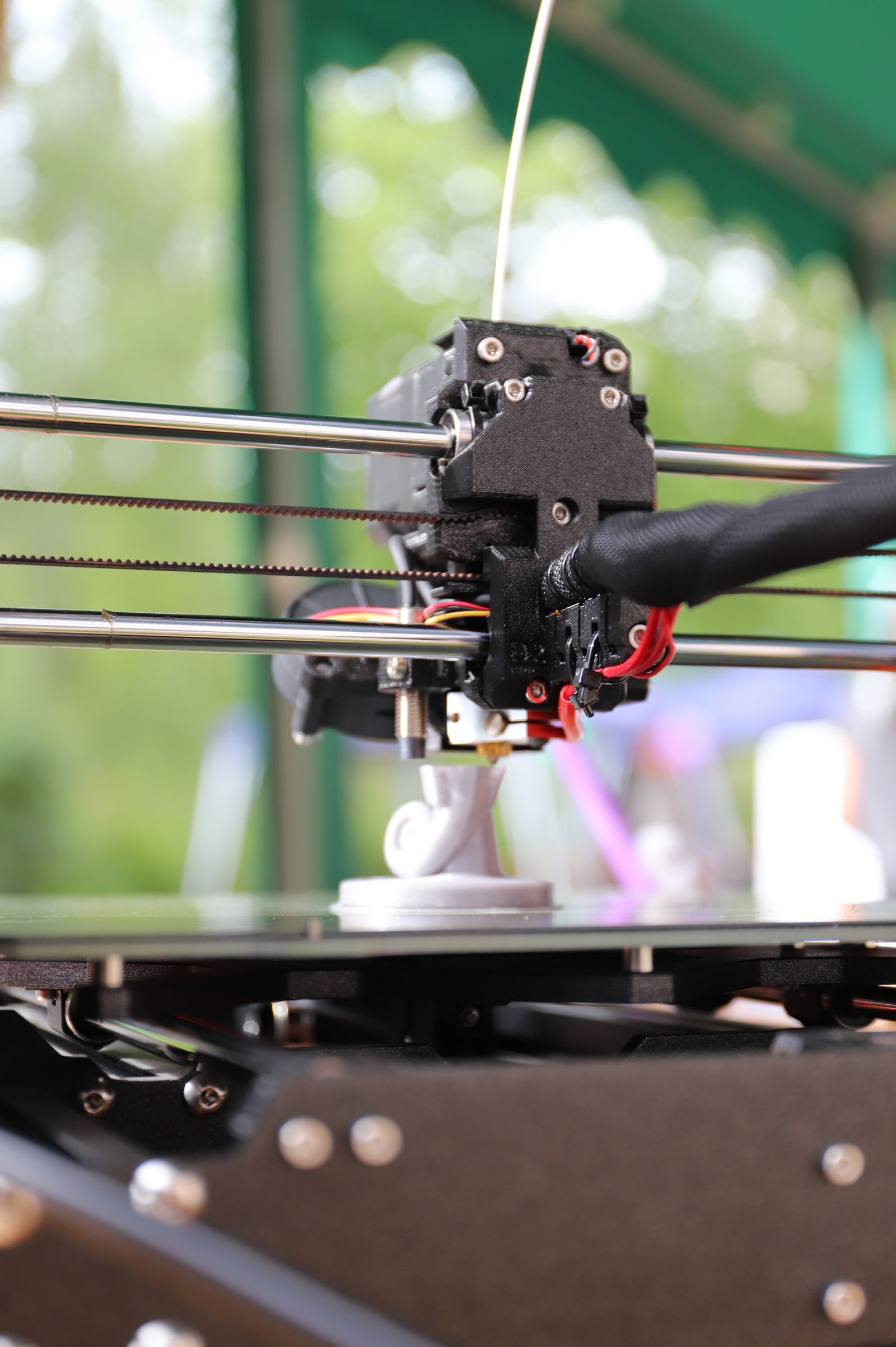 Close up photo of a 3D printer working on a green print