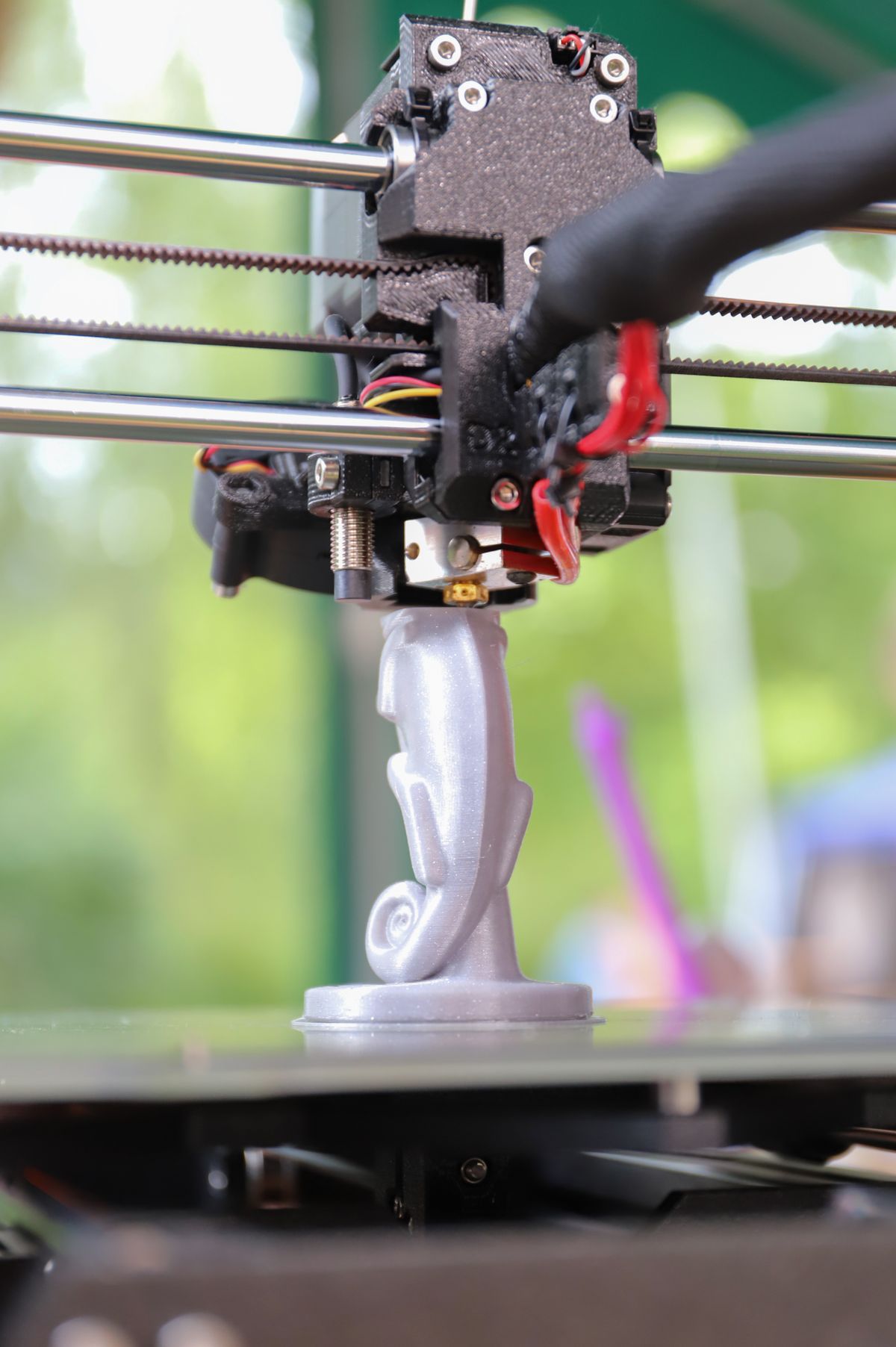 Close-up of a 3D printer creating a decorative figurine