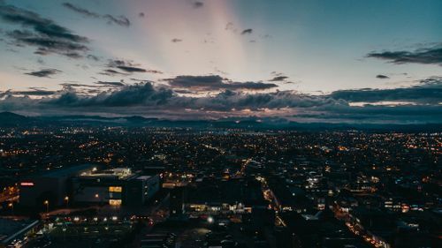 Free Captivating aerial view of Bogotá's skyline at sunset, showcasing a vibrant urban scene. Stock Photo