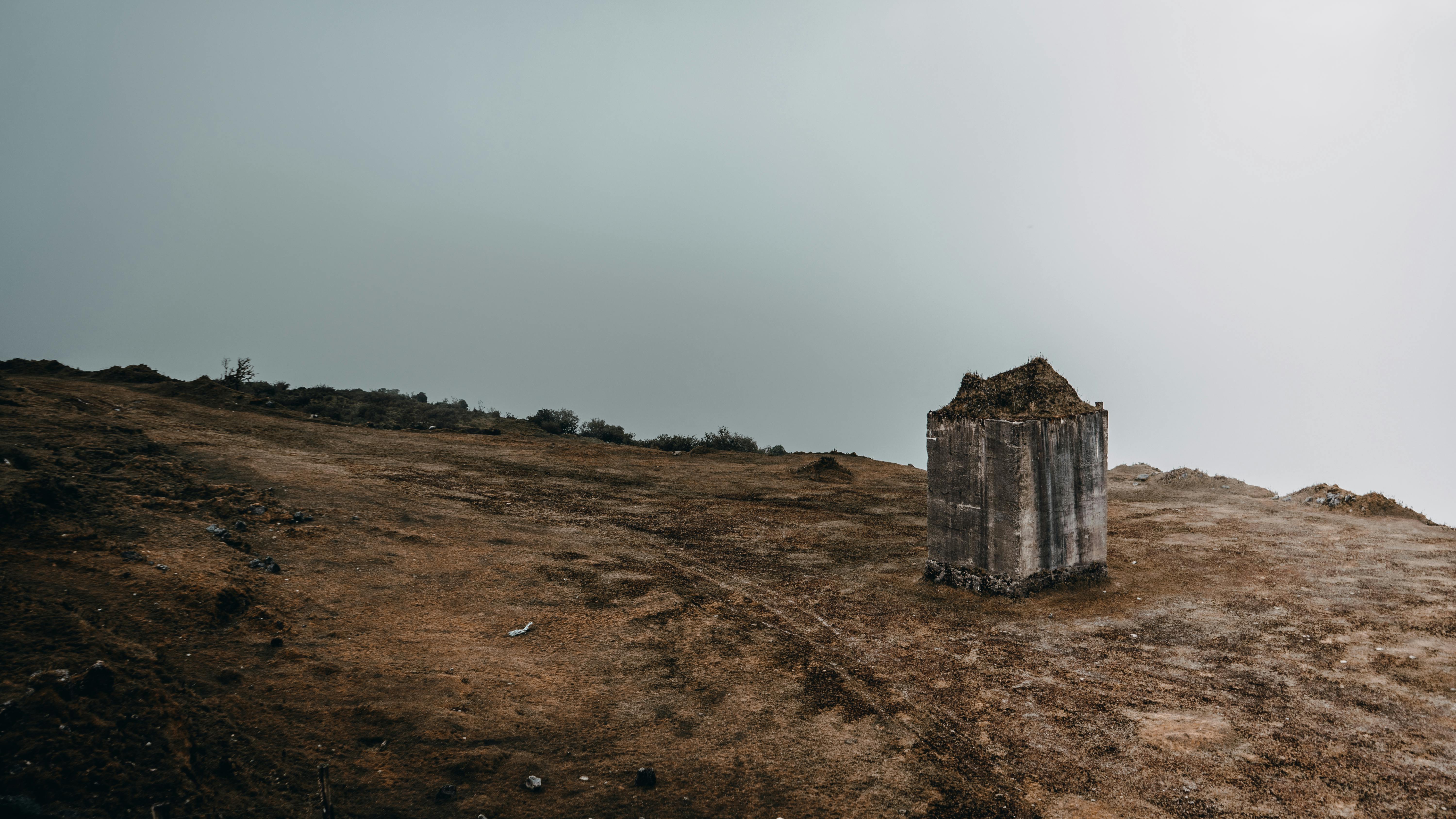 Moody view of an arid landscape with a lone concrete block in La Calera, Colombia.
