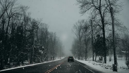 Black car on the Road During Snowfall