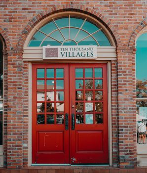 Red Wooden Door on Brown Brick Building