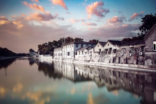 White and Brown Houses Beside Body of Water