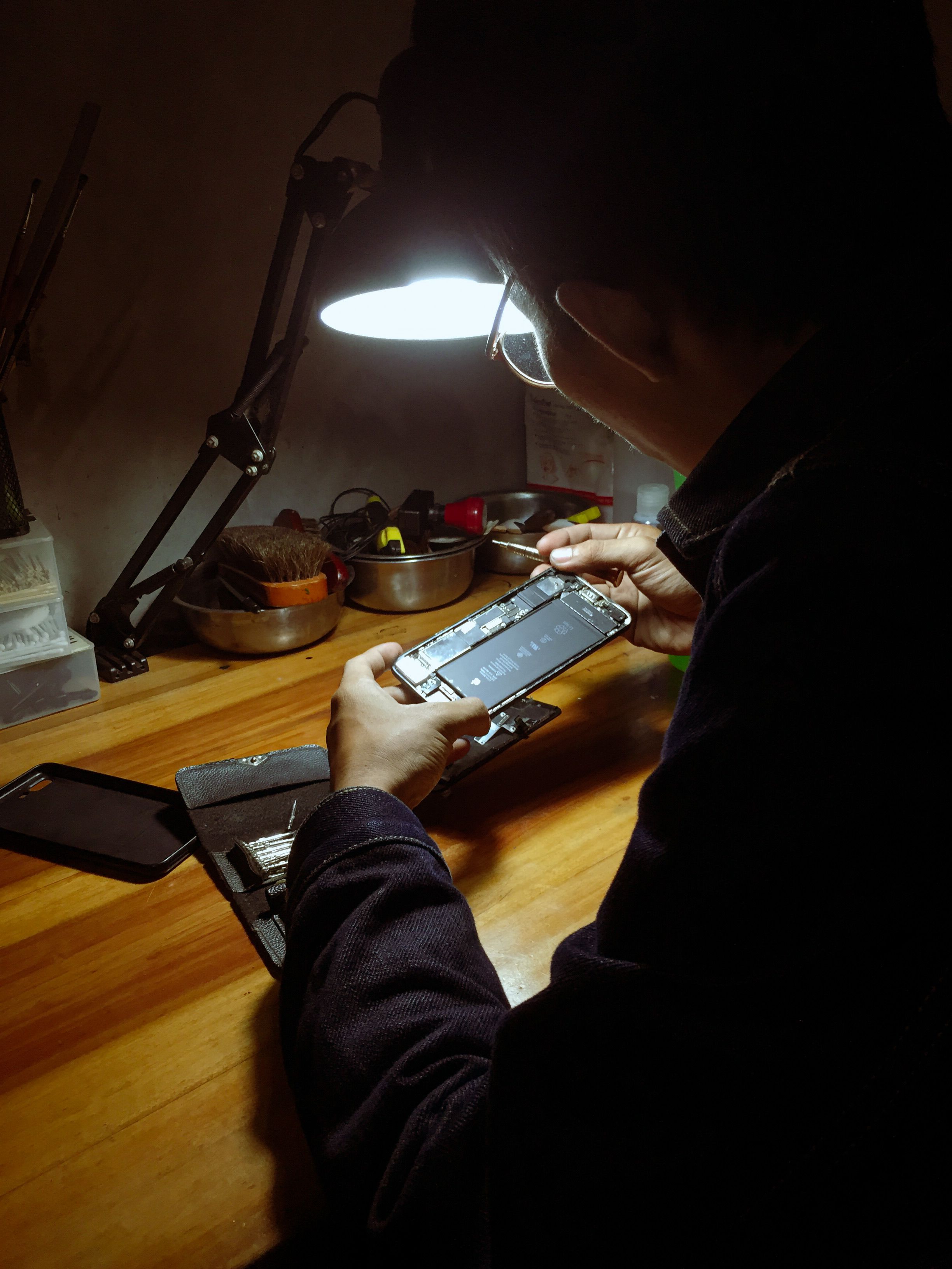 Repair technician working on a smartphone