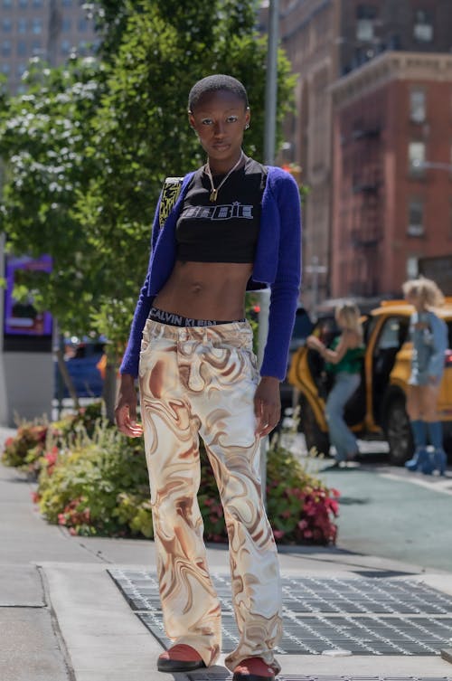 A Woman in Fashionable Outfit Standing on the Street