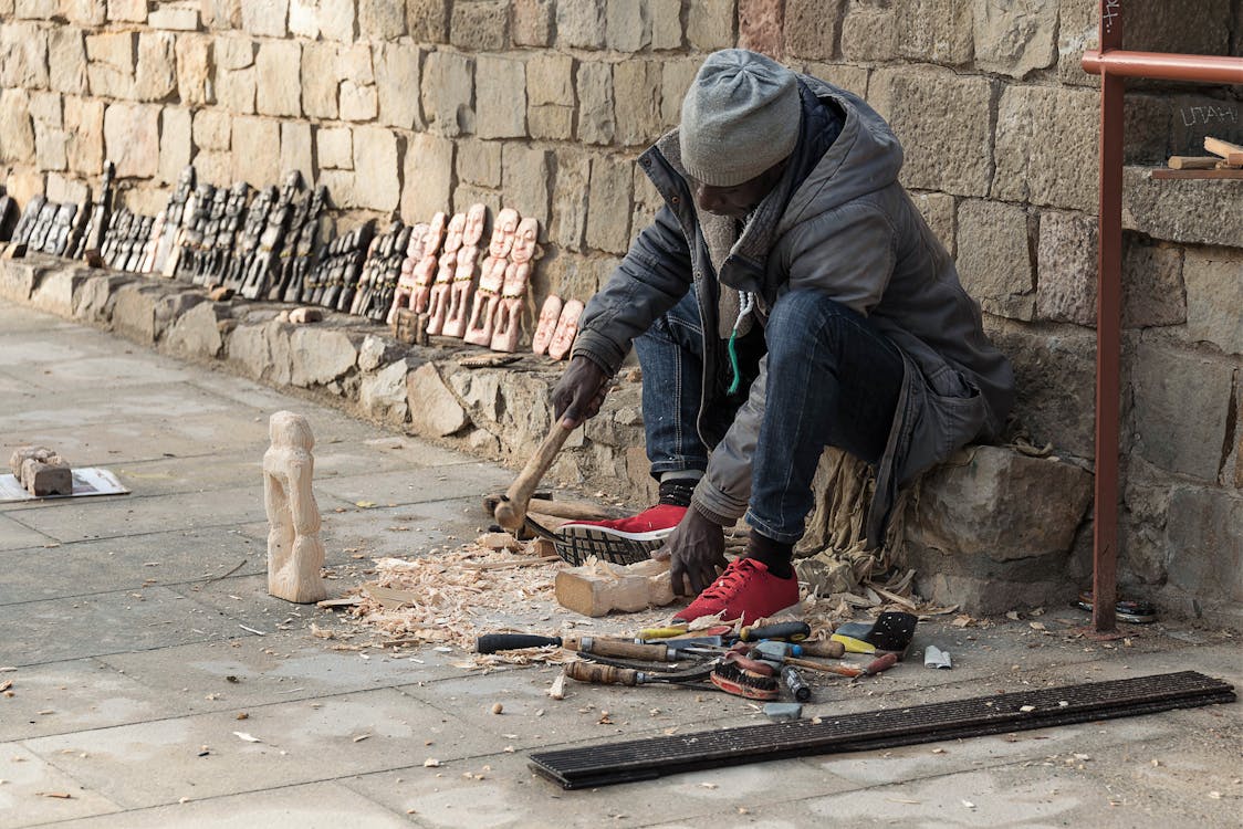 Sculptor Carving Wooden Figures