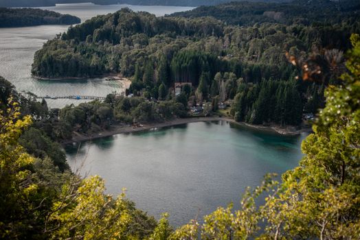 Stunning aerial view of Lake Nahuel Huapi surrounded by lush greenery in Villa La Angostura, Argentina.