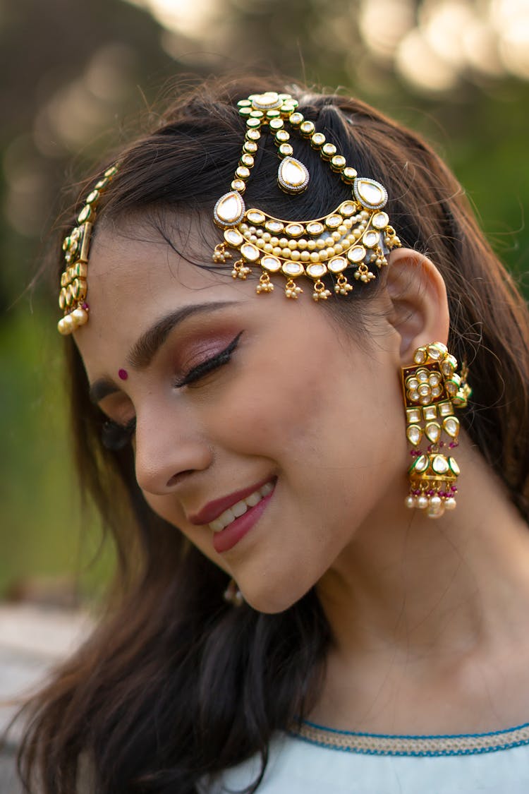 Brunette Wearing Traditional Gold Jewelry