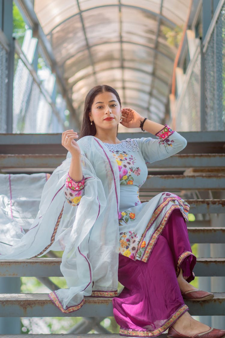 Woman In White Floral Long Sleeve Dress And Purple Pants