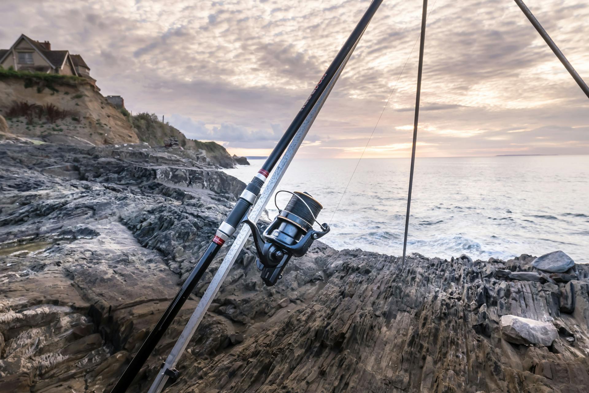 Fishing Rod on Tripod on Sea Shore at Sunset