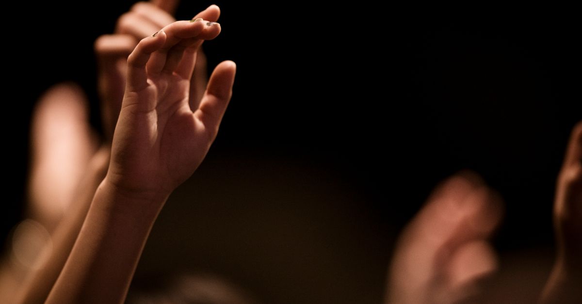 close-up of hands raised in worship at Christ Embassy Loveworld Arena Ho