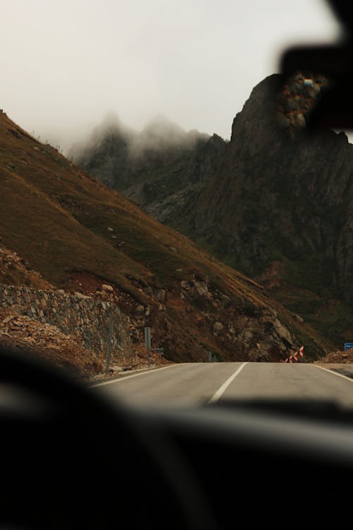 Gray Asphalt Road on the Foot of the Mountain