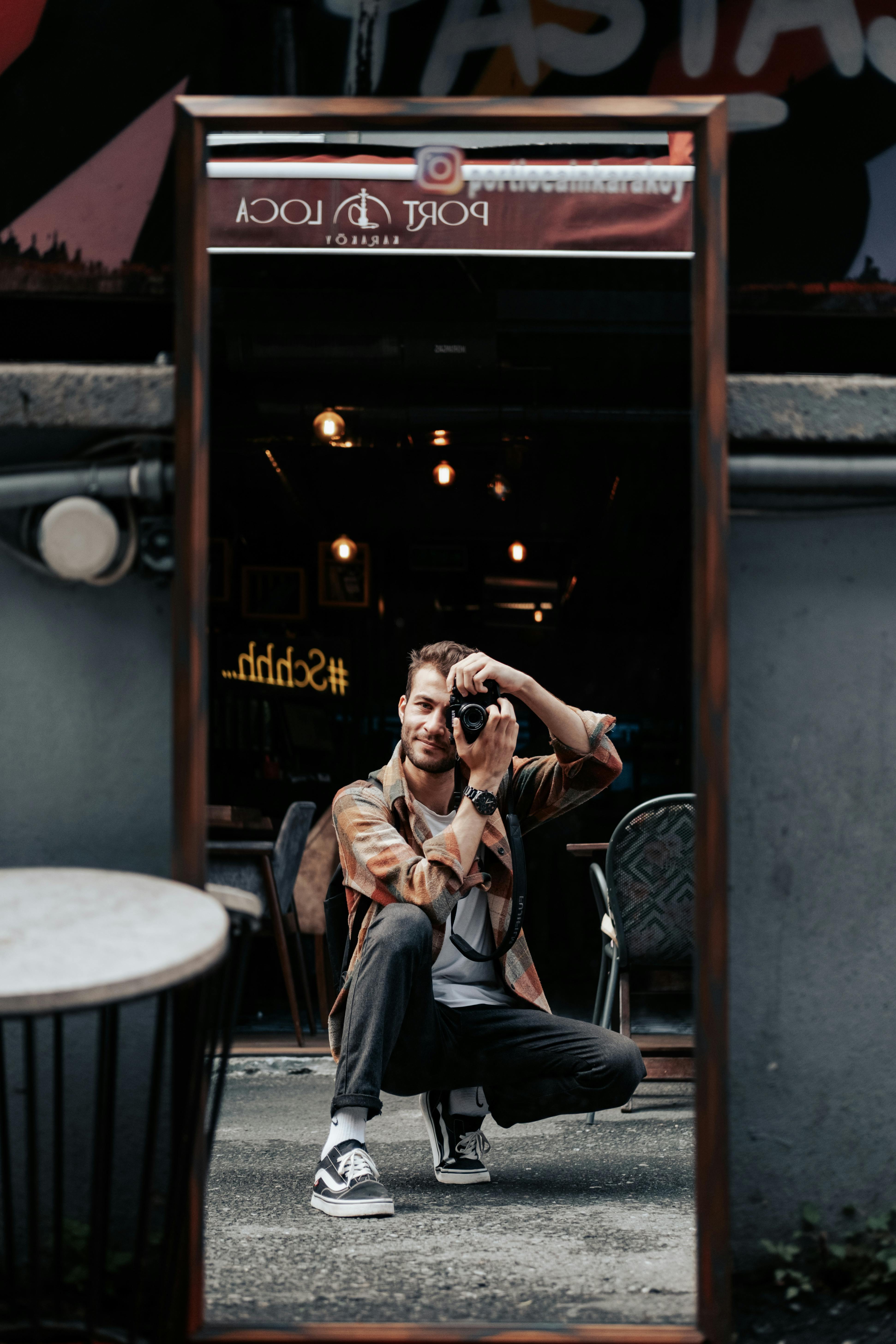 man taking picture in mirror