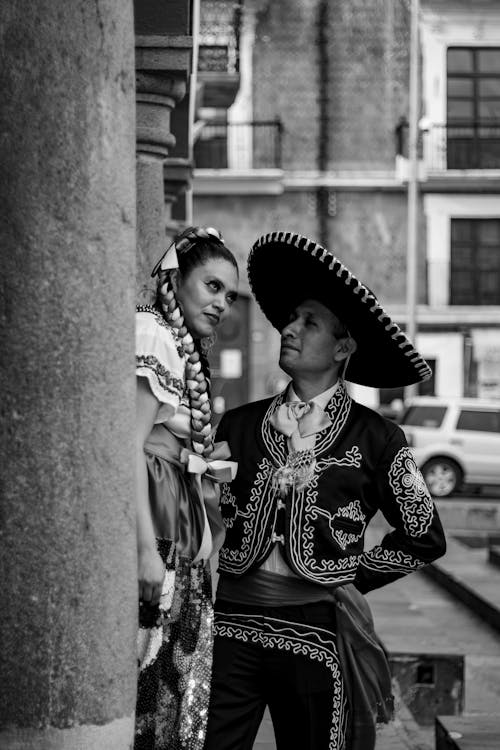 Woman and Man in Traditional Clothing in Black and White