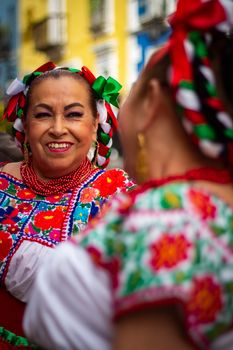 Vibrant portrait of women in traditional Mexican clothing in Puebla, Mexico.
