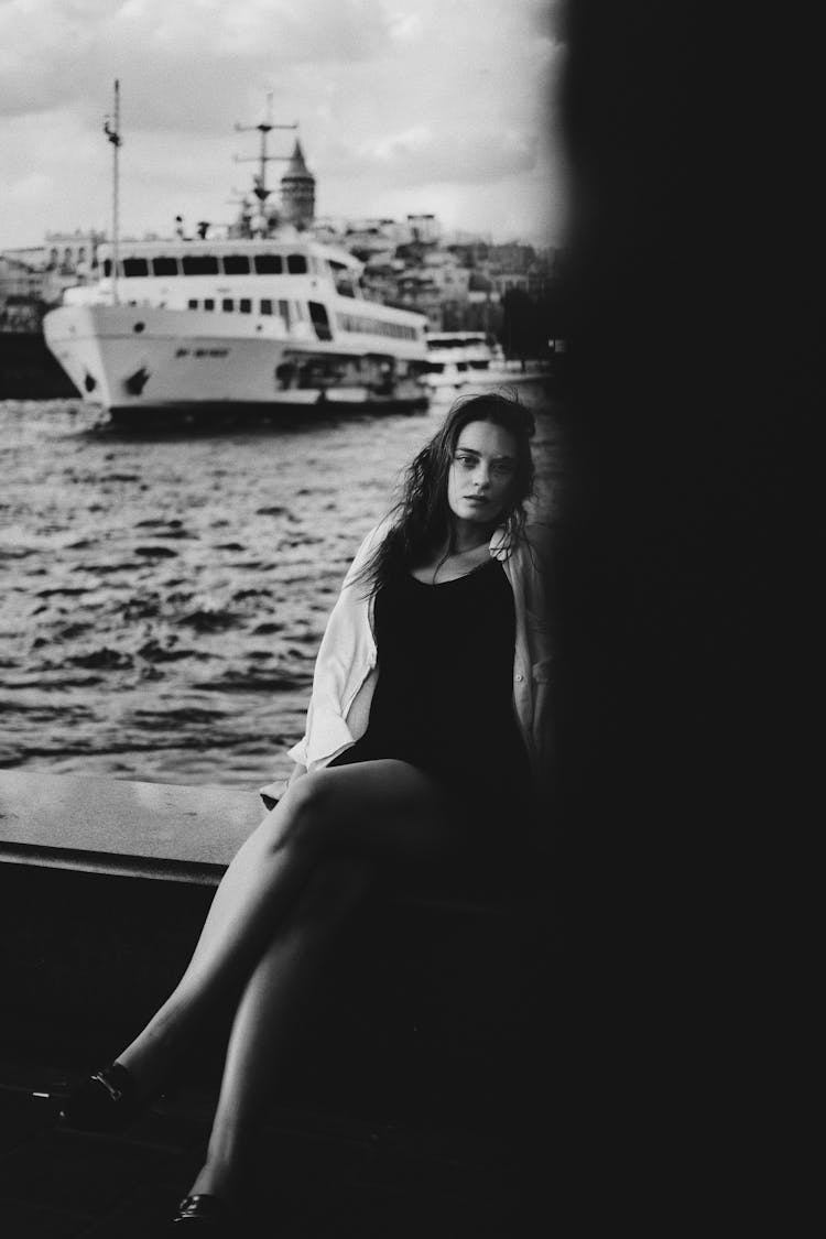 Woman In Black Dress Sitting On Boat