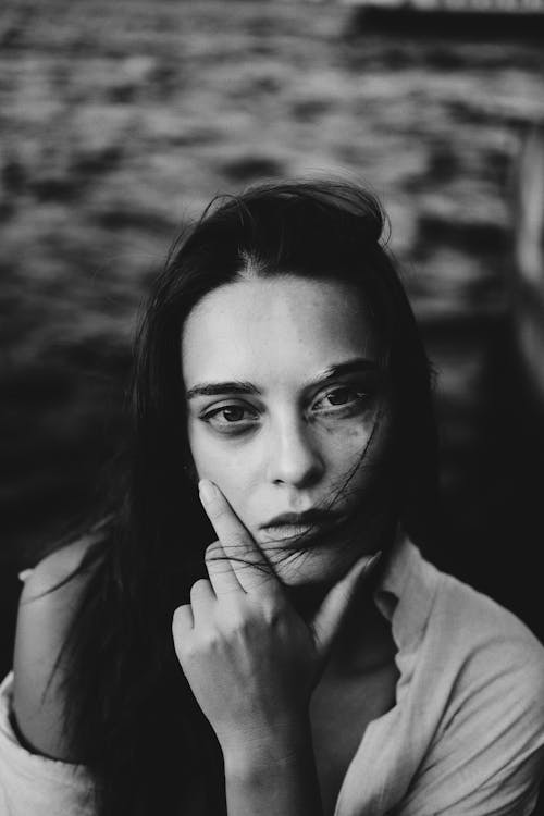 Grayscale Photo of Woman with Her Hand on Her Chin