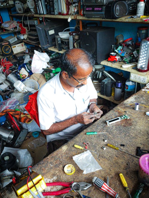 High Angle View of a Man Fixing Tools