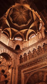 Exploring the ornate architecture of the Mosque-Cathedral's ceiling in Córdoba, Spain.