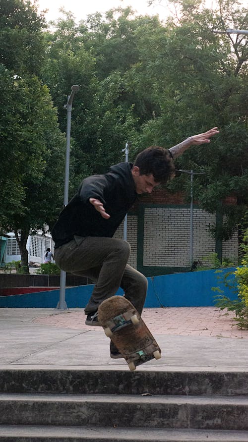 Photo of a Man Doing Skateboard Trick