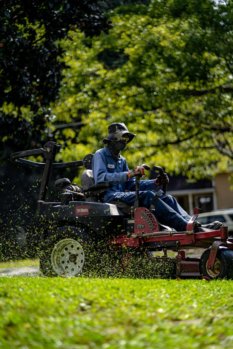 A Person Mowing The Lawn Grass