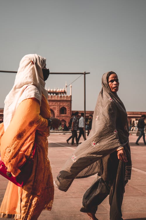 Two Women in Traditional Dress Walking down the Street