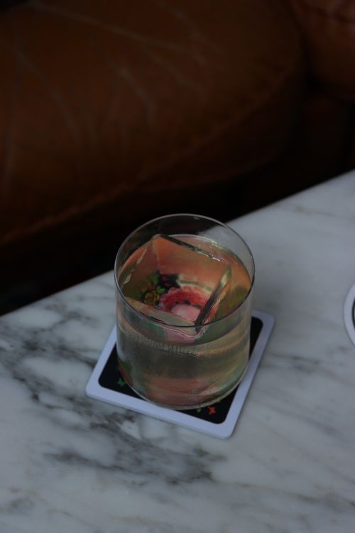 Free Refreshing cocktail served with ice in a glass on a marble table, perfect for relaxation. Stock Photo