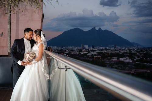 Married Couple Standing on Balcony