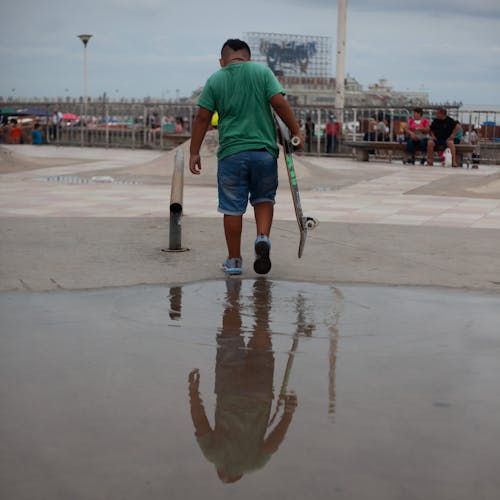 Boy Holding a Skateboard