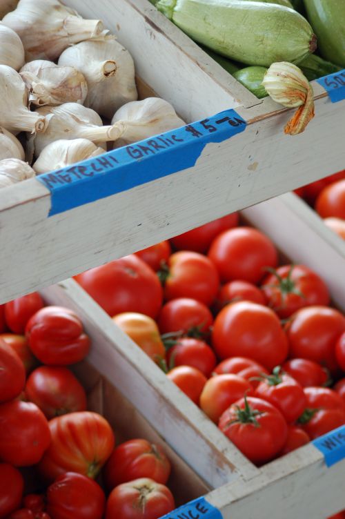 Free Close-up of fresh garlic, tomatoes, and zucchinis at a local farmers market. Stock Photo