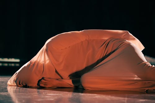 Person Covered in Delicate Fabric Dancing on Stage 