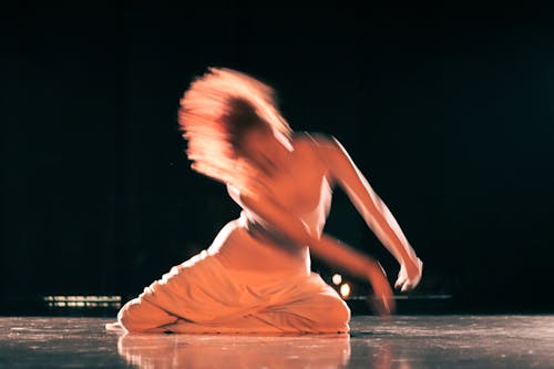 Blurry Photo of a Woman Dancing on Stage