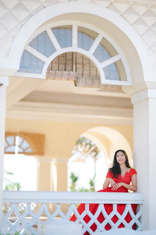 Woman in Red Dress Posing on the Railings