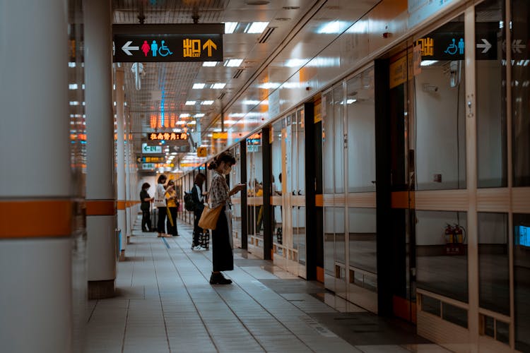 People Waiting Near Doors On Airport