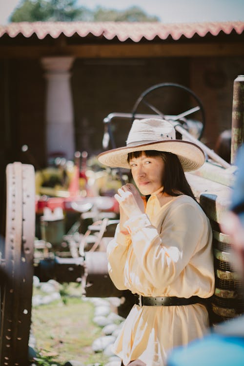 Woman in Long Sleeves and Hat Looking Over Shoulder