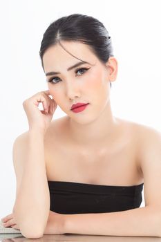 Striking portrait of an elegant woman with red lips and a tube top, showcasing beauty and grace.