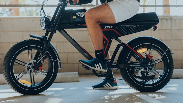 Leg Of Man Sitting On Electric Bike