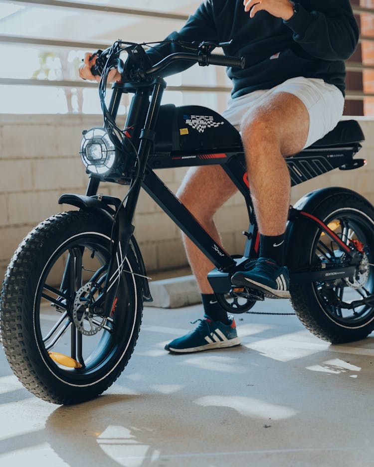 Legs Of Man Sitting On Electric Bike