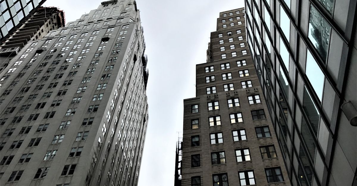 High Rise And Low Rise Building Low-Angle Shot of High Rise Buildings · Free Stock Photo