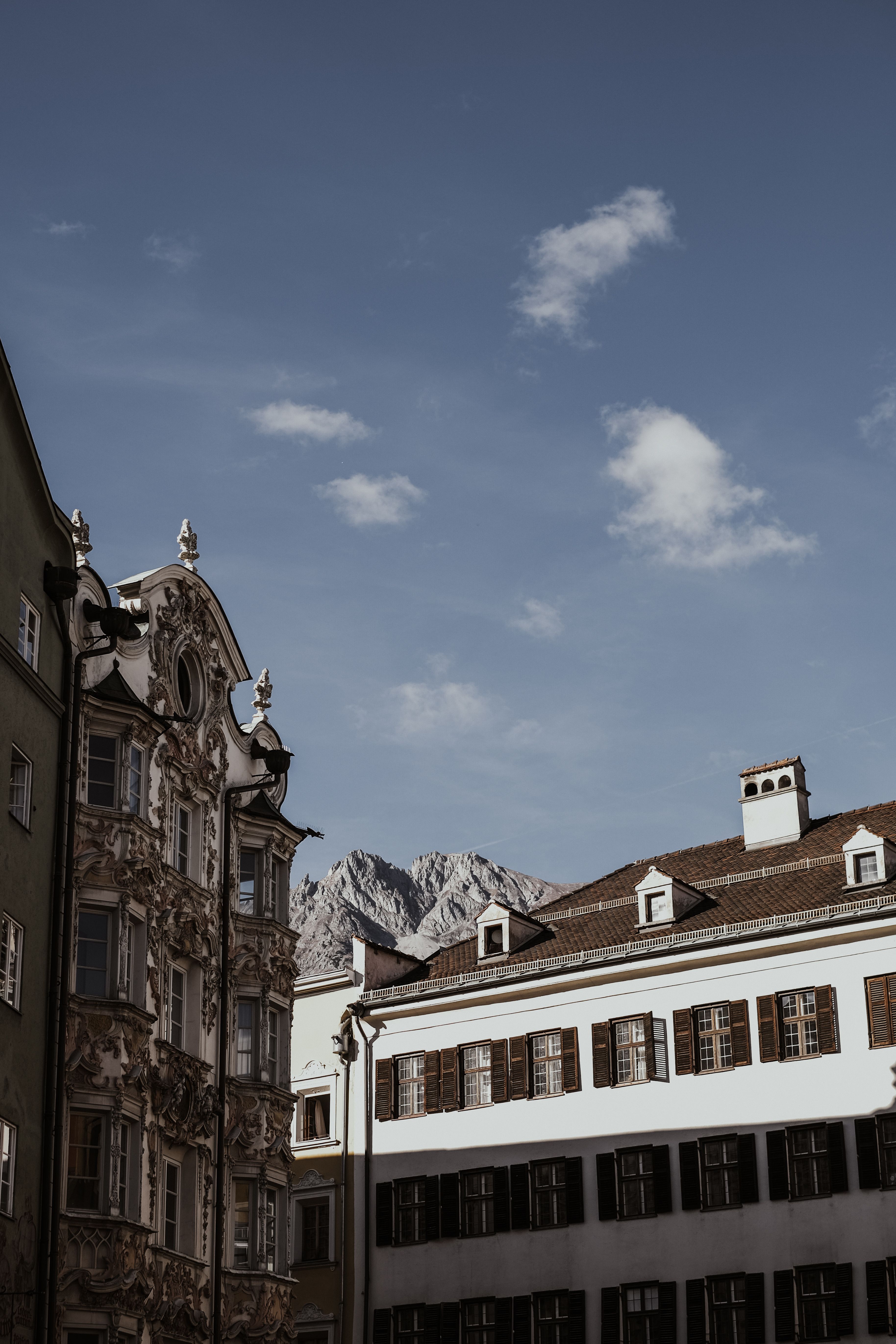 Elegant historic buildings in Salzburg, Austria, with a clear blue sky and the Alps in the background.
