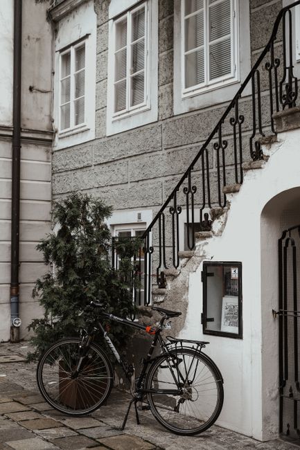 A vintage bicycle parked next to a quaint stone staircase in Salzburg, Austria.
