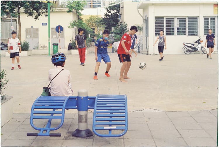 Boys Playing Football In City 