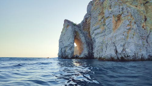 Rock Formation with Arch on Sea 