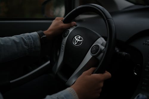 A Person Driving a Toyota Car